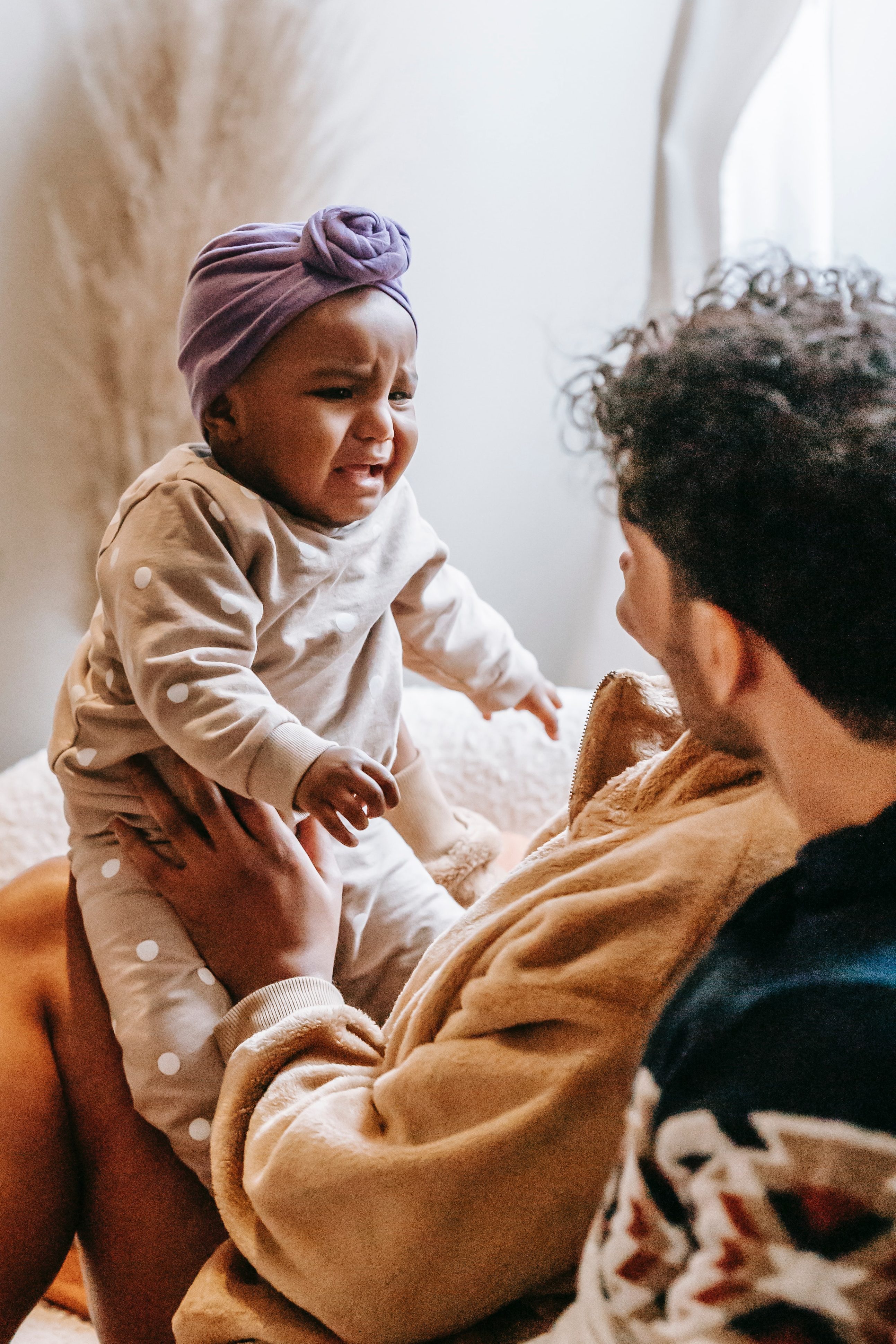 The image shows a baby expressing their feelings to their parents. 
